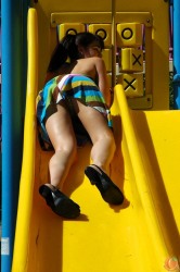 Danielle at the playground in pigtails, skirt, and thong