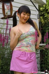 Pigtailed Chinese Babe In Skirt Poses Outdoor