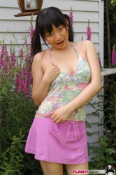 Pigtailed Chinese Babe In Skirt Poses Outdoor