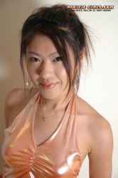 Asian girl in orange dress stretches the vagina